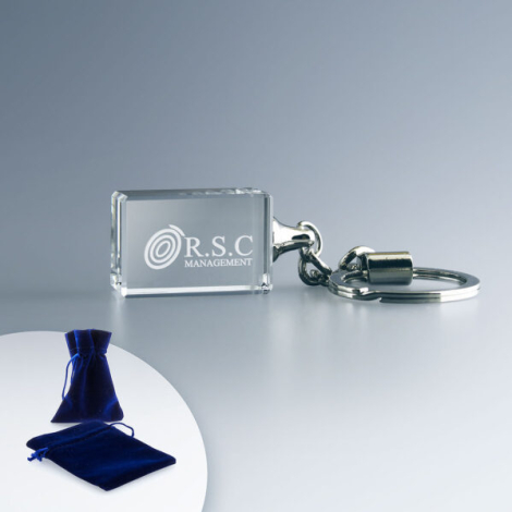 Porte-clés rectangulaire en verre transparent avec anneau métallique, marquage visible au centre