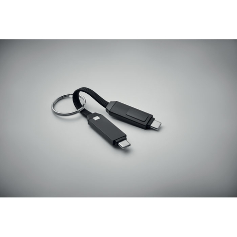 Porte-clés noir avec câble de charge intégré présenté ouvert avec deux connecteurs USB-C, sans personnalisation visible.