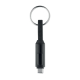 Porte-clés noir avec câble de charge intégré et anneau métallique, présenté de face, sans personnalisation visible.