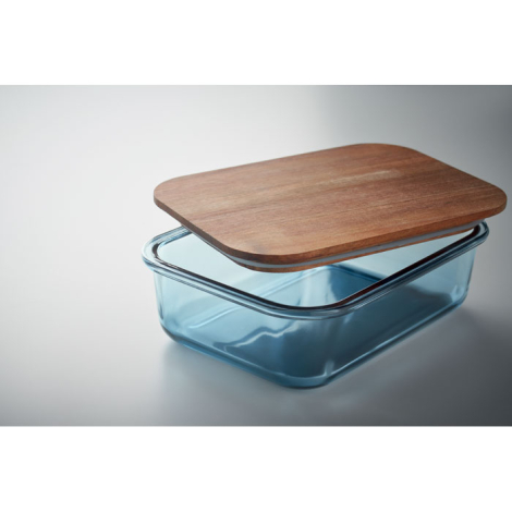 Lunch box en verre bleu translucide avec couvercle en bois posé légèrement ouvert.