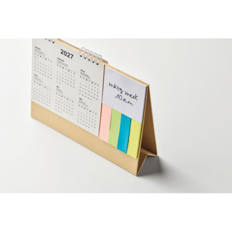 Calendrier de bureau vu de dos avec pages reliées en spirale.