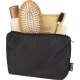 Trousse noire ouverte contenant des produits de soin et accessoires, sans marquage visible.