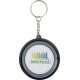 Porte-clés Spinx rond vu de face, surface blanche centrale avec marquage visible.