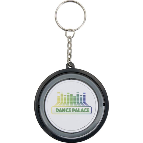 Porte-clés Spinx rond vu de face, surface blanche centrale avec marquage visible.