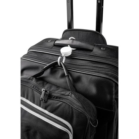 Crochet fixé sur une poignée de valise, suspendant un sac Crochet fixé sur une poignée de valise, suspendant un sac