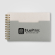Carnet publicitaire gris A6 avec marquage visible sur la couverture. Carnet publicitaire gris A6 avec marquage visible sur la couverture.