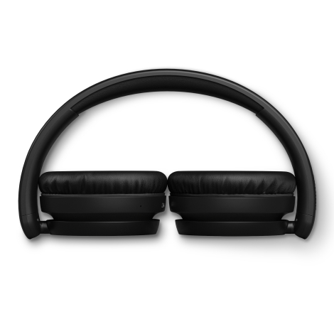Casque Philips TAH5209 noir replié à plat pour rangement compact.