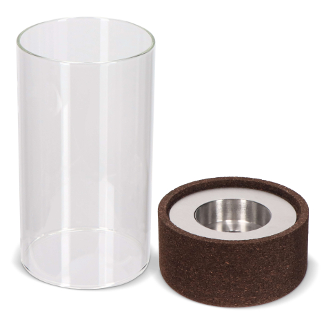 Photophore démonté, avec cylindre en verre à côté de la base en liège intégrant un insert métallique, sans marquage visible.