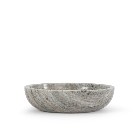 Bol en marbre travertin vu de profil, mettant en avant sa forme évasée et sa base arrondie, sans marquage visible.
