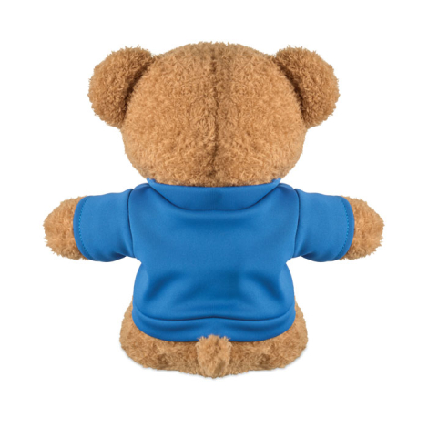 Peluche ourson présentée de dos sur fond blanc, de couleur marron clair, portant un t-shirt bleu dont l’arrière apparaît sans ma
