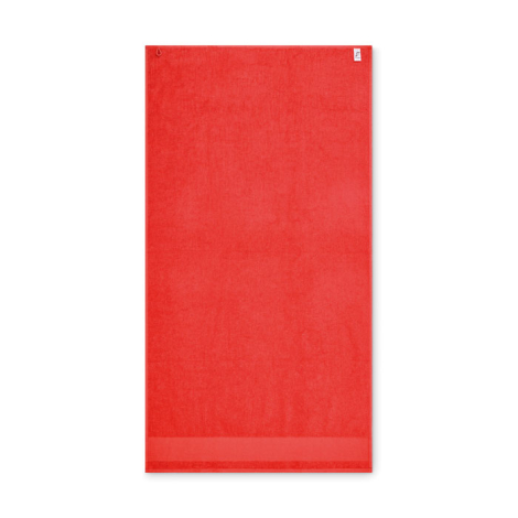 Serviette de bain rectangulaire en coton présentée à plat sur fond blanc, coloris rouge, avec boucle de suspension visible en pa