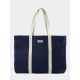 Sac de plage bleu marine vu de face avec étiquette et marquage visible Sac de plage bleu marine vu de face avec étiquette et marquage visible