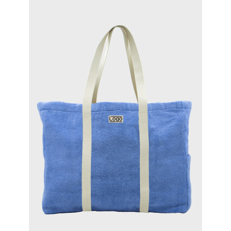 Sac de plage publicitaire personnalisable en coton bio éponge bleu avec anses longues et marquage visible sur la face avant.