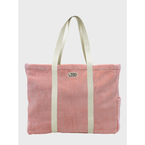 Sac de plage publicitaire personnalisable en coton bio éponge rose avec impression visible sur la face avant.