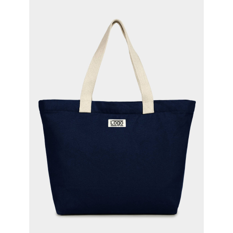 Sac cabas bleu foncé vu de face avec deux anses longues claires et étiquette rectangulaire centrée, personnalisation visible sur