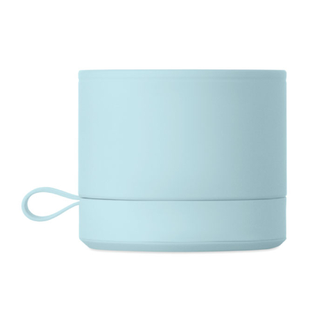 Vue latérale d’un haut-parleur sans fil cylindrique bleu clair présenté sur fond blanc, mettant en évidence la surface unie du c