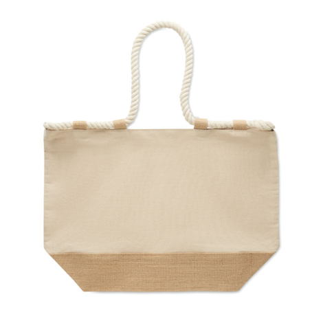 Sac de plage en toile écrue présenté à plat de face sur fond blanc, mettant en évidence la surface principale et la base en jute