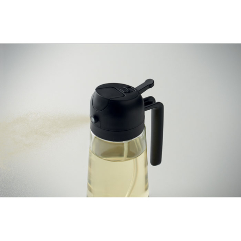 En légère plongée, le vaporisateur partiellement rempli met en avant le bouton de pulvérisation, le couvercle noir et l’anse lat