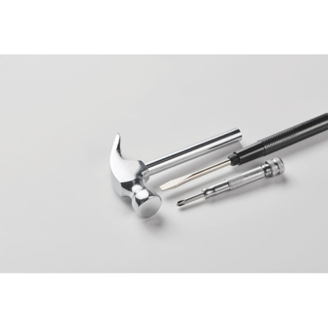 Vue inclinée du marteau démonté avec les différents éléments disposés côte à côte sur fond clair, sans marquage visible.