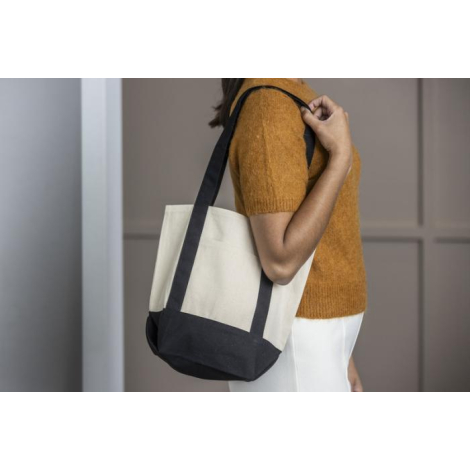 Mini sac shopping écru porté à l’épaule par un mannequin féminin, sans marquage visible sur le sac.