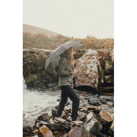 Personne marchant en extérieur avec un parapluie ouvert au-dessus de la tête, sans personnalisation visible sur la toile.