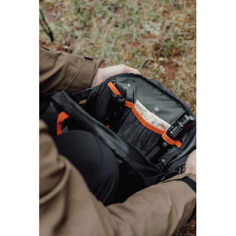 Sac ouvert tenu par une personne montrant les compartiments internes, sans marquage visible.