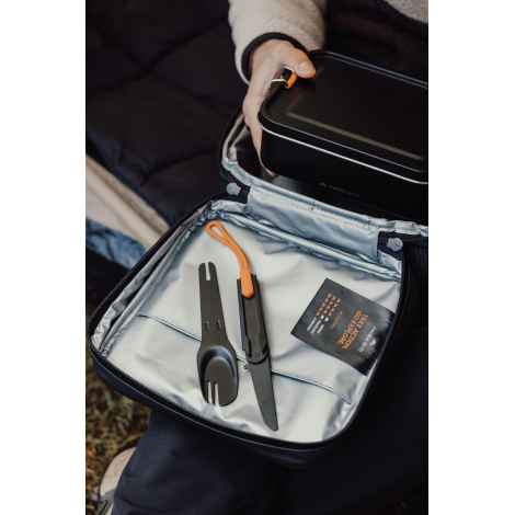 Set de couverts rangé dans un sac avec d’autres éléments, sans marquage visible.