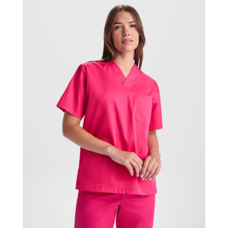 Femme portant un ensemble de service rose avec haut à manches courtes et poches plaquées, sans personnalisation visible.