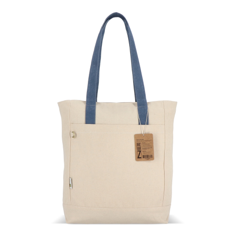 Sac cabas beige en toile avec longues anses bleues et étiquette produit visible sur la face avant, sans marquage apparent.