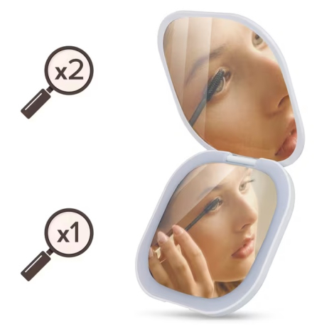 Vue intérieure du miroir montrant les deux niveaux de grossissement, sans marquage apparent.