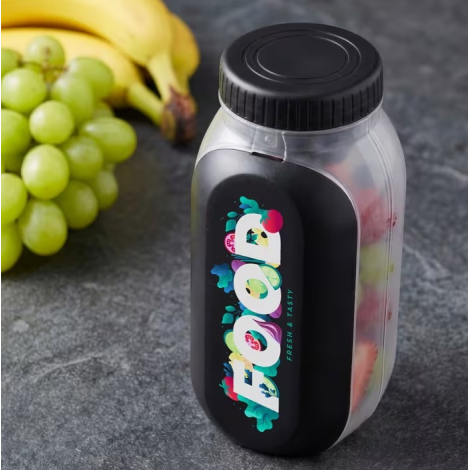 Boîte à lunch remplie de fruits et présentée fermée avec marquage visible sur le dessus.