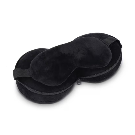 Masque de sommeil noir disposé sur une housse de rangement ouverte, sans marquage apparent.