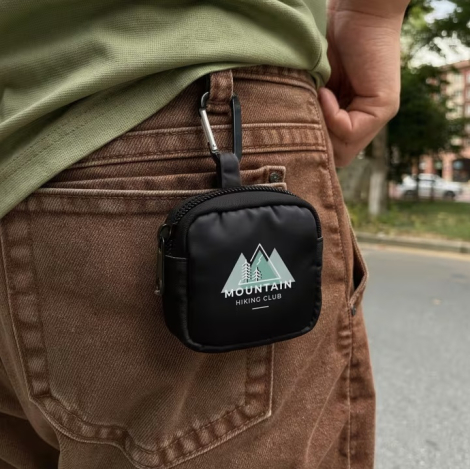 Pochette en nylon pour écouteurs accrochée à un passant de pantalon à l’aide du mousqueton, avec une personnalisation visible su