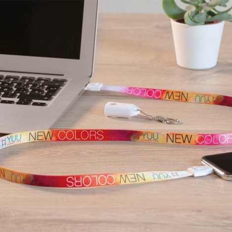 Lanyard connecté à un ordinateur portable et à un smartphone avec personnalisation visible sur la sangle utilisée comme câble de