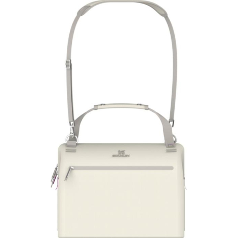 Partie supérieure du sac isotherme crème montrant les poignées de transport et les points d’attache de la bandoulière.