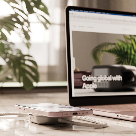 Câble de recharge USB-C utilisé avec un ordinateur portable et un smartphone posé sur le module de charge, présenté dans un envi