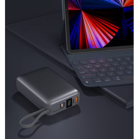 Powerbank posée à côté d'une tablette avec clavier, montrant l'écran LED, les connectiques et la dragonne, sans personnalisation