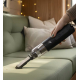 Mini aspirateur souffleur utilisé avec un embout fin pour nettoyer un canapé, sans marquage visible. Mini aspirateur souffleur utilisé avec un embout fin pour nettoyer un canapé, sans marquage visible.