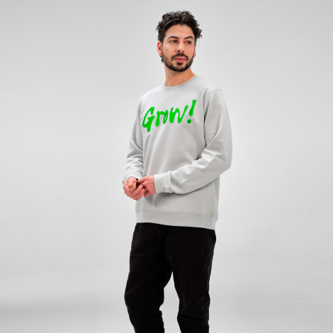 Sweat à col rond unisexe porté par un homme, présenté de trois quarts de devant avec un marquage visible sur le devant.