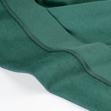 Gros plan sur l'intérieur en French Terry et le bord-côte d'un sweat vert, sans personnalisation visible.