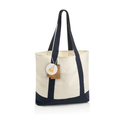 Sac cabas écru et bleu marine présenté de trois quarts, avec longues anses contrastées, renfort inférieur assorti, poche extérie
