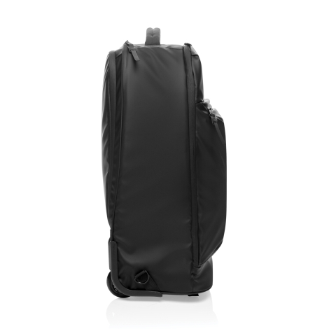 Vue de l’autre profil du sac à dos noir, avec une poche latérale, plusieurs fermetures zippées et une roulette visible à la base