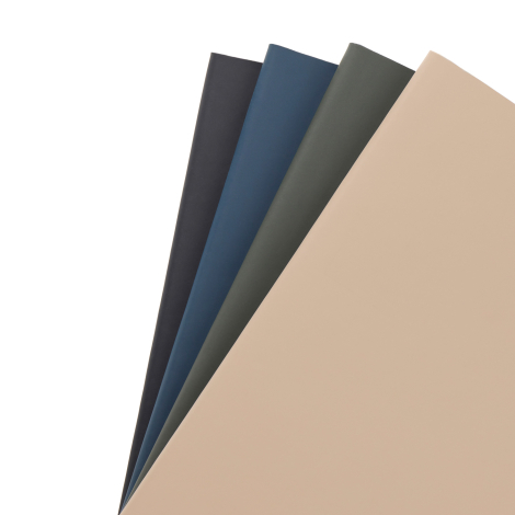 Quatre carnets de notes fermés disposés en éventail, avec couvertures mates noire, bleue, vert foncé et beige.