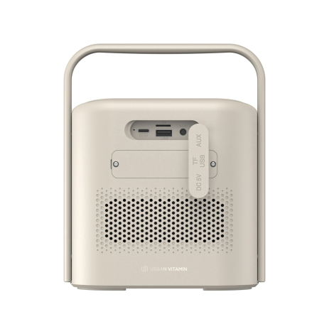 Vue arrière d’une enceinte portable beige avec poignée intégrée, grille perforée et connectiques regroupées sous un cache, compr