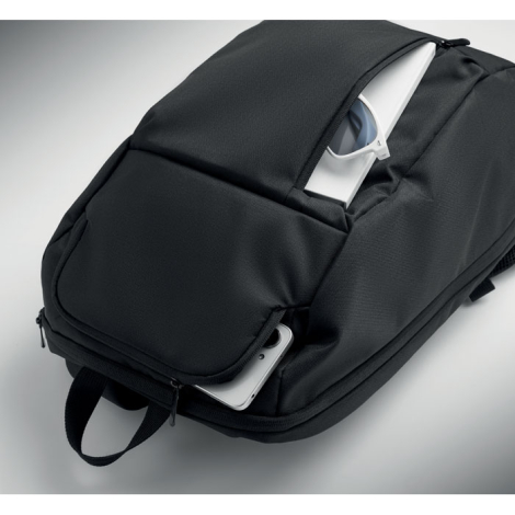 Le sac à dos est ouvert à plat sur toute sa hauteur, laissant apparaître plusieurs compartiments intérieurs, avec une paire de l