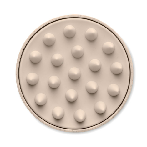 Vue de dessous de la brosse de massage ronde, montrant la répartition de ses picots souples en silicone aux extrémités arrondies