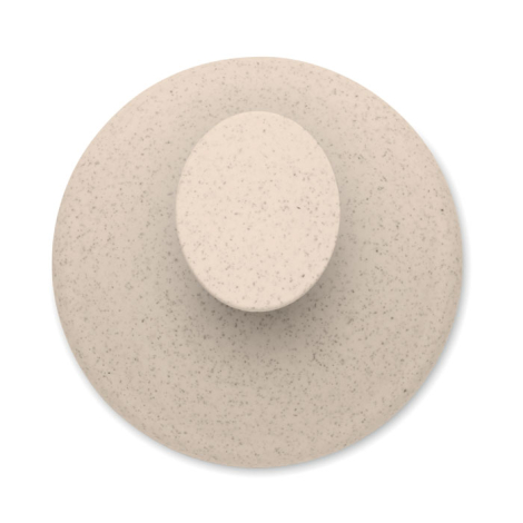 Vue de dessus de la brosse de massage beige mouchetée, centrée sur sa poignée ronde.