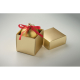 Boule de Noël dorée à finition satinée présentée dans une boîte cadeau assortie ouverte, avec un nœud en ruban rouge sur le dess