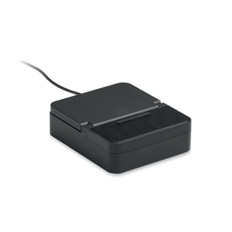 Enceinte noire vue de trois quarts avec support pour téléphone rabattu à plat, grille visible sur la partie supérieure et câble 
