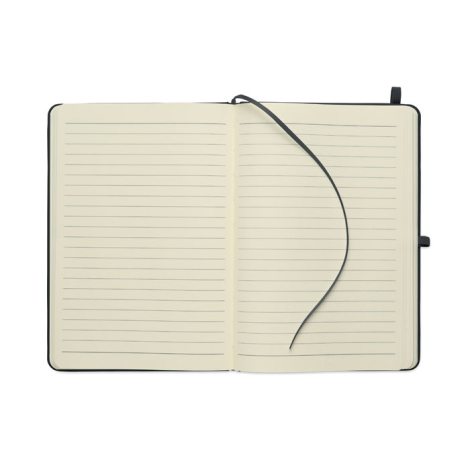 Carnet A5 ouvert montrant deux pages lignées couleur crème, avec ruban marque-page posé sur la page de droite et passant pour st